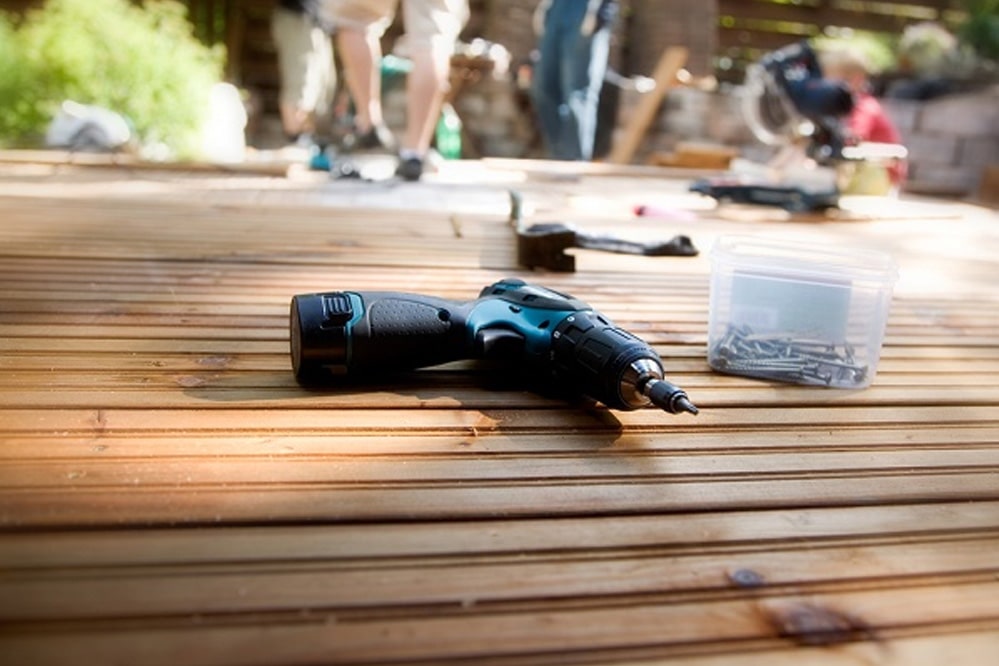 Drill laying on wooden deck